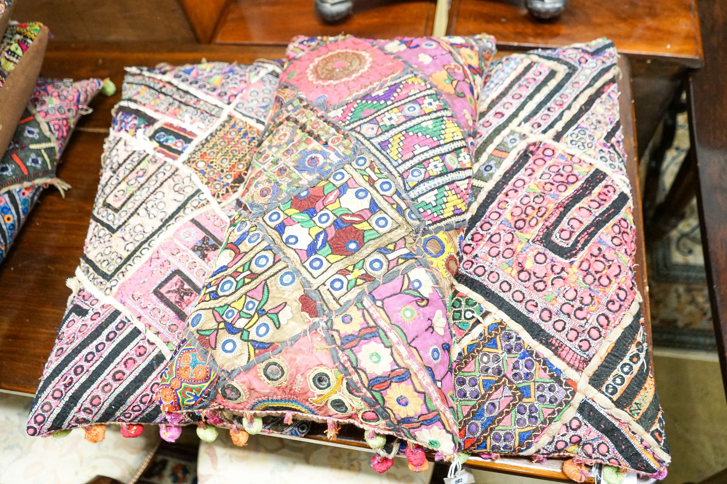 Eight Indian embroidered cushions, 60 x 30cm